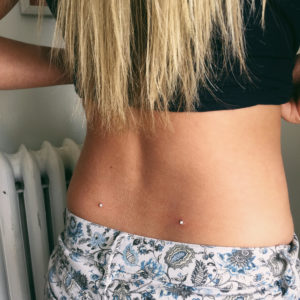 Back Dimples Dermal Piercing at Almost Famous Body Piercing
